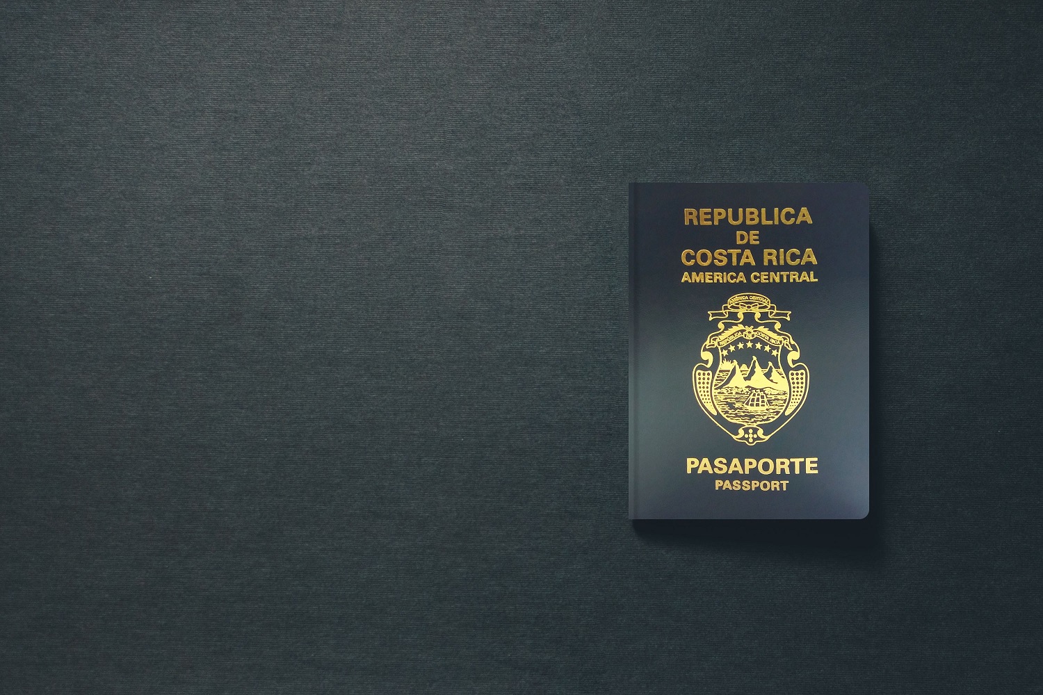 A Costa Rican passport against a dark background.